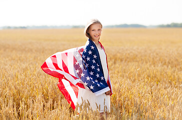 Image showing happy girl in american flag on cereal field