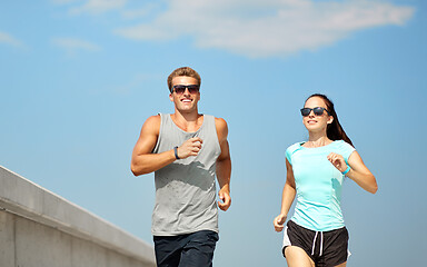 Image showing couple in sports clothes running outdoors