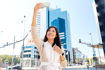 Image showing asian woman taking selfie by smartphone in city