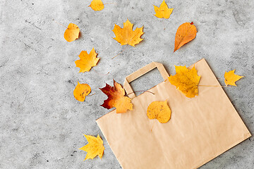 Image showing autumn leaves and paper bag on grey stone