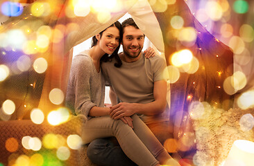 Image showing happy couple in kids tent at home