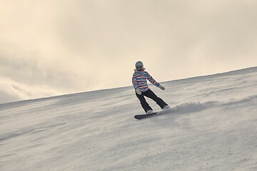 Image showing Female snowboarder in sun flare