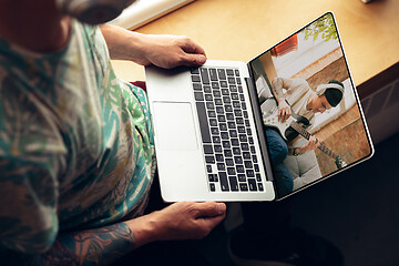 Image showing Man watching online music concert at home during insulation, COVID-19 quarantine