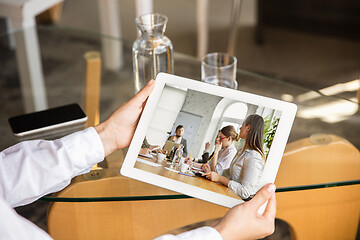 Image showing Young doctor working online with laptop, has online conference with colleagues from workplace