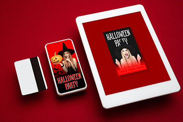 Image showing Young woman in hat as a witch on device screen and red background, mock up with copyspace