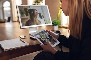 Image showing Woman choosing what to watch at home during insulation, COVID-19 quarantine