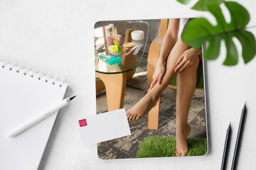 Image showing Tablet with promotion of spa salon, cosmetics, beauty and self-care. Copyspace for ad