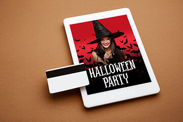 Image showing Young woman in hat as a witch on device screen background, mock up with copyspace