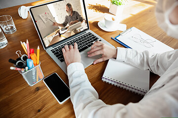 Image showing Young doctor working online with laptop, has online conference with colleague from workplace