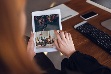 Image showing Woman choosing what to watch at home during insulation, COVID-19 quarantine