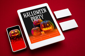 Image showing Scary pumpkin on device screen background, mock up with copyspace