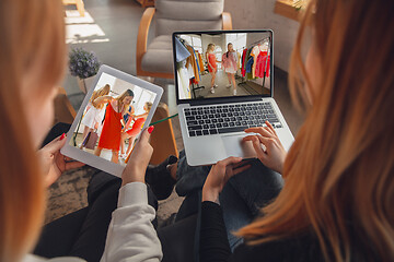 Image showing Two friends watching online shopping, TV or cinema together with devices