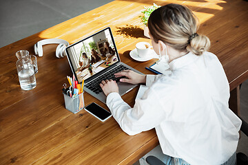 Image showing Young doctor working online with laptop, has online conference with colleagues from workplace