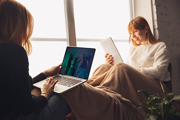 Image showing Two friends watching online party, TV or cinema together with devices