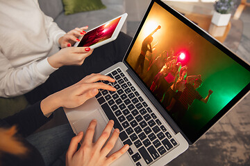 Image showing Two friends watching online party, TV or cinema together with devices