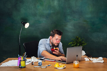 Image showing Ill young man with fever and cold looks suffering at home