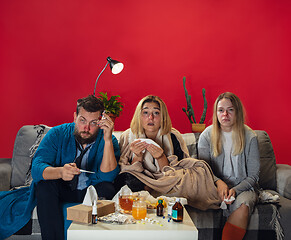 Image showing Ill young people, friends or family with fever and cold look suffering at home