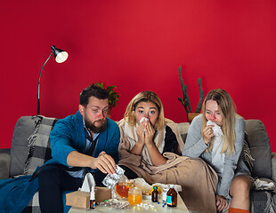 Image showing Ill young people, friends or family with fever and cold look suffering at home