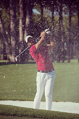 Image showing golfer hitting a sand bunker shot