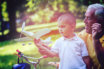 Image showing grandfather and child have fun  in park