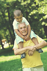 Image showing happy grandfather and child in park