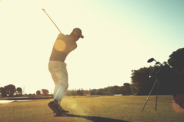 Image showing golf player hitting shot with club