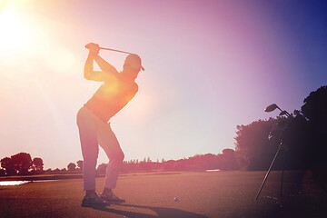 Image showing golf player hitting shot with club