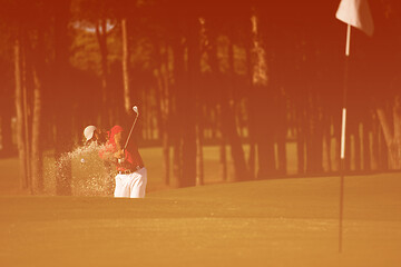 Image showing golfer hitting a sand bunker shot