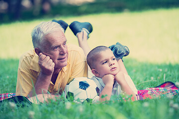 Image showing grandfather and child have fun  in park