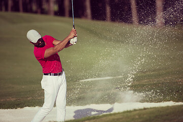 Image showing golfer hitting a sand bunker shot