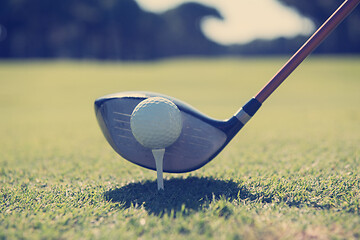 Image showing golf player placing ball on tee