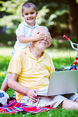 Image showing grandfather and child using laptop