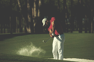 Image showing golfer hitting a sand bunker shot