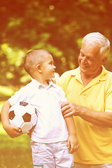 Image showing grandfather and child have fun  in park