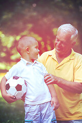 Image showing grandfather and child have fun  in park