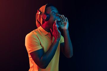 Image showing The young handsome hipster man listening music with headphones