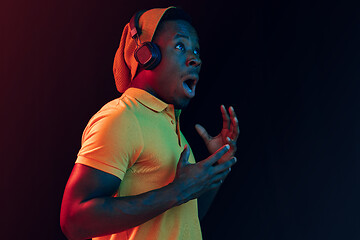 Image showing The young handsome hipster man listening music with headphones