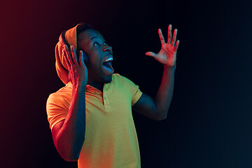 Image showing The young handsome hipster man listening music with headphones