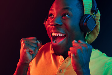 Image showing The young handsome hipster man listening music with headphones