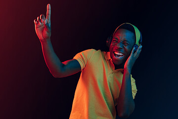 Image showing The young handsome hipster man listening music with headphones