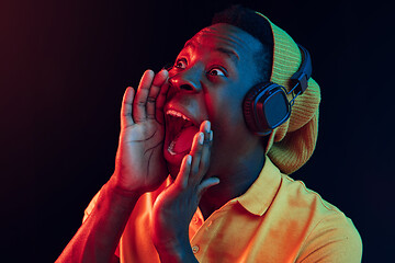 Image showing The young handsome hipster man listening music with headphones