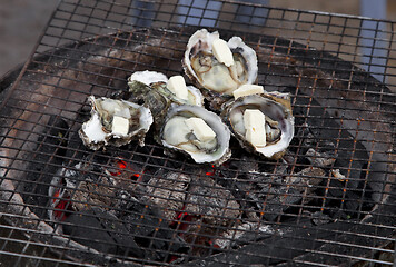 Image showing Shellfish frying on a street oven