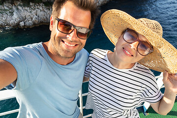 Image showing Beautiful, romantic caucasian couple taking selfie self portrait photo on summer vacations traveling by cruse ship ferry boat.