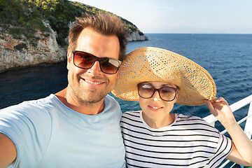 Image showing Beautiful, romantic caucasian couple taking selfie self portrait photo on summer vacations traveling by cruse ship ferry boat.