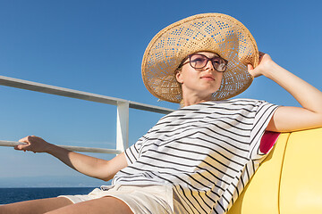 Image showing Beautiful, romantic blonde woman taking selfie self portrait photo on summer vacations traveling by cruse ship ferry boat.