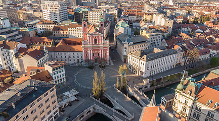 Image showing Aerial drone view of Preseren Squere and Triple Bridge over Ljubljanica river,Tromostovje, Ljubljana, Slovenia. Empty streets during corona virus pandemic social distancing measures