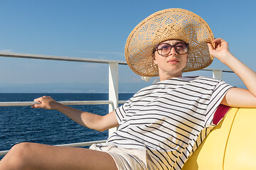 Image showing Beautiful, romantic blonde woman taking selfie self portrait photo on summer vacations traveling by cruse ship ferry boat.