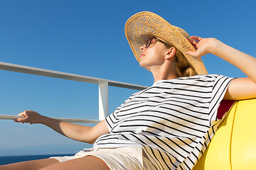 Image showing Beautiful, romantic blonde woman taking selfie self portrait photo on summer vacations traveling by cruse ship ferry boat.