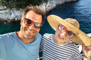 Image showing Beautiful, romantic caucasian couple taking selfie self portrait photo on summer vacations traveling by cruse ship ferry boat.