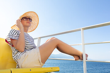 Image showing Beautiful, romantic blonde woman taking selfie self portrait photo on summer vacations traveling by cruse ship ferry boat.